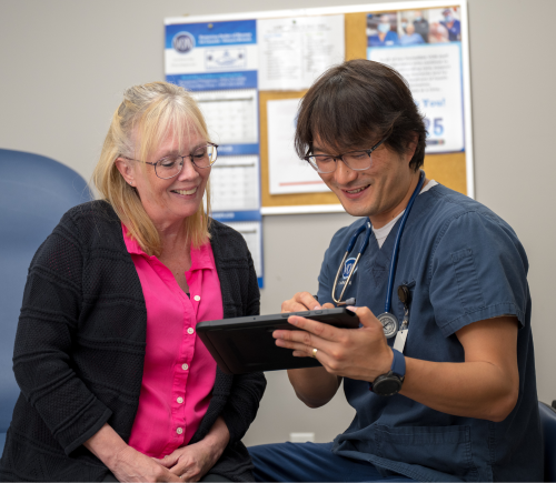 VON staff and client reviewing client chart on a tablet device.