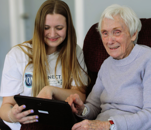 Staff member and client using technology in ADP