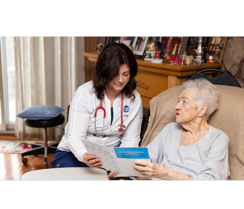 A female VON nurse reviewing information in a booklet with a senior female. Written below is "Photo credit: the Sobey Foundation