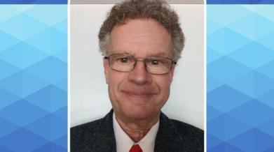 John Cunningham, with tie and glasses