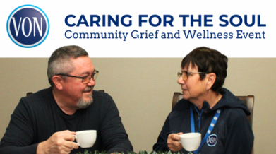 Two people, gentleman on the left and women on the right, sitting at a table, both holding a teacup having a dicussion. 