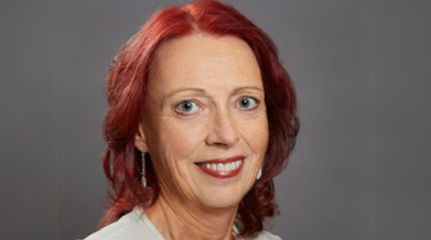 Monique posing for a headshot photo