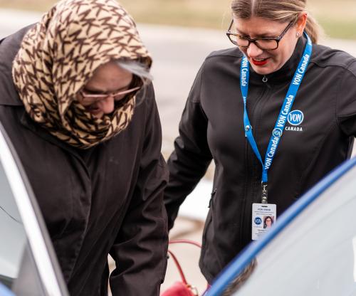 VON staff assisting older adult into a car.