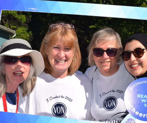 group of individuals gathered inside a physical frame to celebrate the von activity challenge 